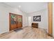Welcoming entryway featuring wood-look flooring, paneled wood doors, and a bench for seating at 6900 Driskell Cir, Cumming, GA 30041