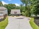 Charming home exterior showcasing a circular driveway and well-manicured landscaping at 6900 Driskell Cir, Cumming, GA 30041