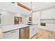 Bright kitchen featuring a marble countertop island, stainless steel appliances, and ample cabinet space at 6900 Driskell Cir, Cumming, GA 30041