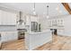 Modern kitchen featuring stainless steel appliances, a wine rack, and a large island at 6900 Driskell Cir, Cumming, GA 30041