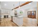 Open concept kitchen with stone countertops, stainless appliances, and wine storage at 6900 Driskell Cir, Cumming, GA 30041