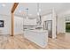 Well-lit kitchen with stainless steel appliances and a kitchen island with a stone countertop at 6900 Driskell Cir, Cumming, GA 30041