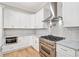 Kitchen with stainless steel appliances, herringbone tile backsplash, and stone countertops at 6900 Driskell Cir, Cumming, GA 30041