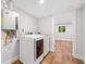 Laundry room with modern washer, dryer and tankless hot water heater at 6900 Driskell Cir, Cumming, GA 30041