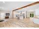 Spacious open concept living room and kitchen area with wood beam and wood-look flooring at 6900 Driskell Cir, Cumming, GA 30041
