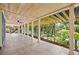 Spacious covered patio with ceiling fan overlooking a lush, wooded landscape at 6900 Driskell Cir, Cumming, GA 30041
