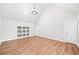 Spacious bonus room with wood floors, built-in shelving, high ceilings, and plenty of natural light at 6900 Driskell Cir, Cumming, GA 30041