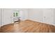 Bright room featuring wood floors and two entryways flanking a sun-filled window at 6900 Driskell Cir, Cumming, GA 30041