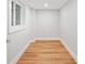 A versatile room with hardwood floors, fresh paint, and natural light; ready for your personal touch at 6900 Driskell Cir, Cumming, GA 30041