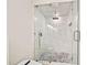 Modern bathroom design includes sleek glass shower with gray stone floor and rainfall shower head at 6900 Driskell Cir, Cumming, GA 30041