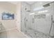 Modern glass enclosed shower with dual shower heads, stone accents, and bright lighting at 6900 Driskell Cir, Cumming, GA 30041