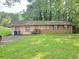 Single story home with a lawn and driveway, featuring mixed siding and brick at 715 Plainville Sw Dr, Atlanta, GA 30331