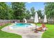 Backyard featuring a pool, lounge chairs, and lush landscaping at 10 Callaway Ct, Hiram, GA 30141