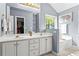 Bathroom featuring double sinks, tub, walk-in closet, and tiled floors at 10 Callaway Ct, Hiram, GA 30141