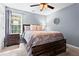 Bedroom with a ceiling fan, neutral walls, and large window at 10 Callaway Ct, Hiram, GA 30141