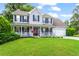 Beautiful two-story home with a lovely front porch, attached garage, and lush green lawn at 10 Callaway Ct, Hiram, GA 30141