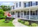 Inviting front porch featuring cozy seating, decorative plants, and a welcoming entryway at 10 Callaway Ct, Hiram, GA 30141