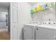 A laundry room with two machines and shelving at 10 Callaway Ct, Hiram, GA 30141