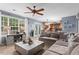 Spacious living room with a large window, comfortable sofa, and seamless flow to the kitchen at 10 Callaway Ct, Hiram, GA 30141