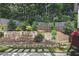 Landscaped backyard showcasing a tiered garden with plants, rock detail, and a barbecue grill, enhancing outdoor living at 1244 Harris Commons Pl, Roswell, GA 30076