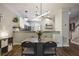 Inviting dining area featuring stylish lighting fixtures, with an open view of the kitchen and natural light at 1244 Harris Commons Pl, Roswell, GA 30076