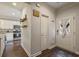 Inviting entryway and view into kitchen, showcasing wood floors and modern design elements at 1244 Harris Commons Pl, Roswell, GA 30076