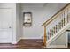 Hallway with stairs and wood floors, creating an inviting transition to the upper levels at 1244 Harris Commons Pl, Roswell, GA 30076
