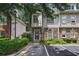 Attractive townhome featuring a stone facade, manicured landscaping, and designated parking space at 1244 Harris Commons Pl, Roswell, GA 30076