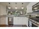 Open kitchen with granite countertops and stainless appliances, seamlessly flowing into living area at 1244 Harris Commons Pl, Roswell, GA 30076
