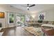 Bright living room with hardwood floors, a comfortable sectional sofa, and sliding glass doors at 1244 Harris Commons Pl, Roswell, GA 30076