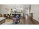 Cozy living room featuring hardwood floors, stylish decor, and an open layout flowing into the kitchen and dining area at 1244 Harris Commons Pl, Roswell, GA 30076