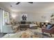 Comfortable living room with large sectional, stylish decor, and ample natural light at 1244 Harris Commons Pl, Roswell, GA 30076