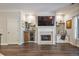 Elegant living room with a fireplace, built-in shelving, and a window seat, perfect for relaxation and entertaining at 1244 Harris Commons Pl, Roswell, GA 30076