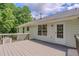 Beautifully landscaped backyard with a spacious deck, mature trees, and green lawn at 3781 Deercreek Dr, Powder Springs, GA 30127