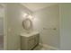 Bathroom featuring a sink with vanity, a round mirror and gray walls at 3781 Deercreek Dr, Powder Springs, GA 30127
