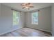 Bright bedroom featuring a ceiling fan, gray walls, and two windows at 3781 Deercreek Dr, Powder Springs, GA 30127