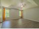 Bright bedroom featuring a ceiling fan, gray walls, tray ceilings and two windows at 3781 Deercreek Dr, Powder Springs, GA 30127