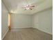 Bright bedroom featuring a ceiling fan, gray walls, tray ceilings and one window at 3781 Deercreek Dr, Powder Springs, GA 30127