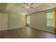 Bright bedroom featuring a ceiling fan, gray walls, tray ceilings and two windows at 3781 Deercreek Dr, Powder Springs, GA 30127