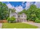 Charming two-story home features a well-manicured lawn, lush trees, and a two-car garage, blending comfort and curb appeal at 3781 Deercreek Dr, Powder Springs, GA 30127