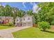 Beautiful two-story home with a well-manicured lawn and a two-car garage, set amongst lush trees at 3781 Deercreek Dr, Powder Springs, GA 30127
