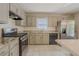 Kitchen featuring stainless steel appliances, light wood cabinets, and tile flooring at 3781 Deercreek Dr, Powder Springs, GA 30127