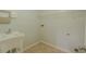 Practical laundry room with a utility sink, overhead shelving, and tile flooring at 3781 Deercreek Dr, Powder Springs, GA 30127