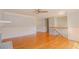 Bright living room with hardwood floors, fireplace, and paneled walls, connecting seamlessly to other spaces at 3781 Deercreek Dr, Powder Springs, GA 30127