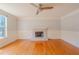 Bright living room featuring a fireplace, hardwood floors, and natural light from a window at 3781 Deercreek Dr, Powder Springs, GA 30127