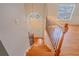 Wooden staircase with decorative iron railing and view of entry, offering a bright and welcoming ambiance at 3781 Deercreek Dr, Powder Springs, GA 30127