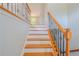 Elegant staircase featuring hardwood steps and wrought iron railing, leading to the upper level at 3781 Deercreek Dr, Powder Springs, GA 30127