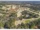 Aerial view of golf course with lush fairways, water hazards, and surrounding woodlands at 4178 Castle Pines Ct, Tucker, GA 30084