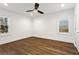 A clean bedroom features wood floors and a ceiling fan at 4178 Castle Pines Ct, Tucker, GA 30084