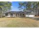 Charming single-story home with a white brick exterior, well-manicured lawn, and an attached two car garage at 4178 Castle Pines Ct, Tucker, GA 30084